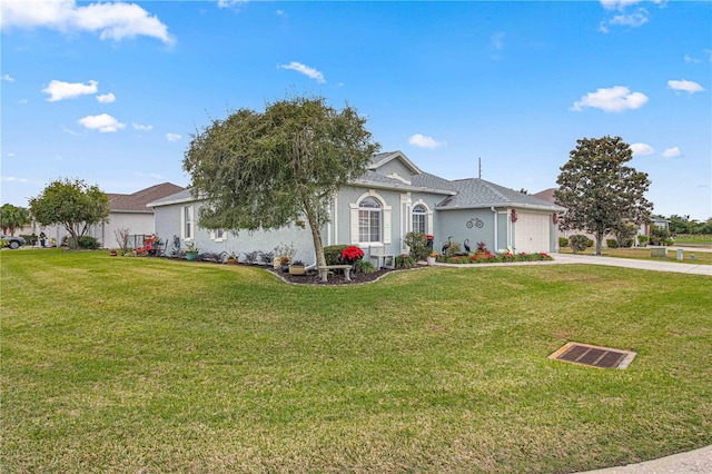 single story home featuring a garage and a front yard