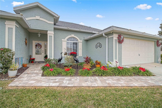 view of front of property with a garage and a front lawn