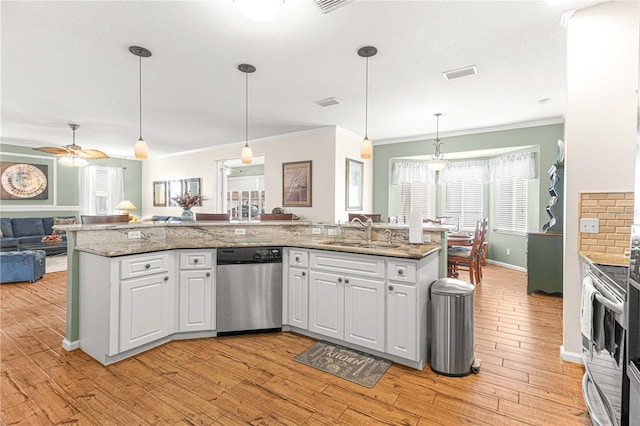 kitchen featuring white cabinetry, sink, pendant lighting, and appliances with stainless steel finishes