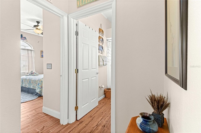 corridor with light hardwood / wood-style flooring