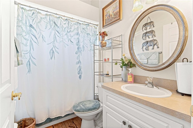 bathroom with a shower with shower curtain, vanity, toilet, and hardwood / wood-style floors