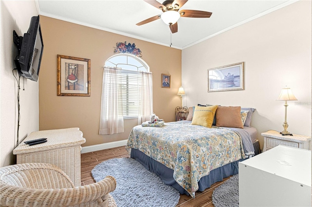 bedroom with hardwood / wood-style flooring, ceiling fan, and crown molding