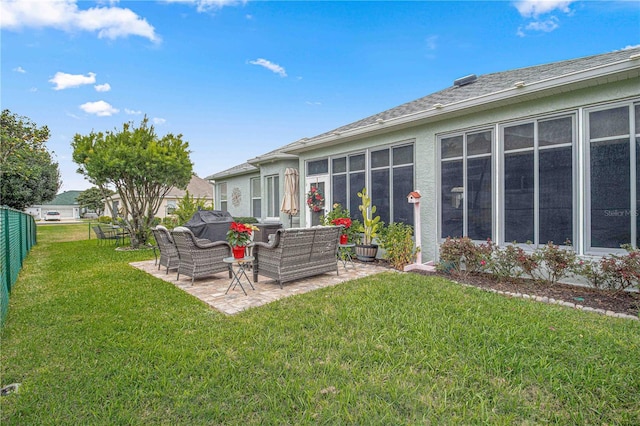 rear view of house with an outdoor living space, a sunroom, a yard, and a patio area