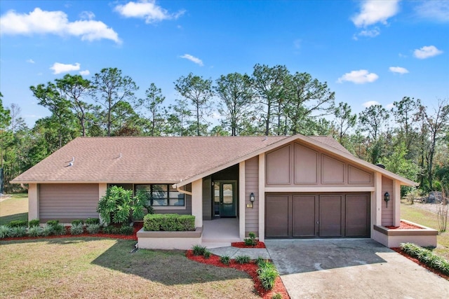 ranch-style home with a garage and a front lawn