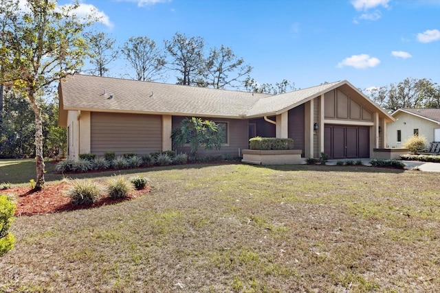 single story home with a garage and a front lawn