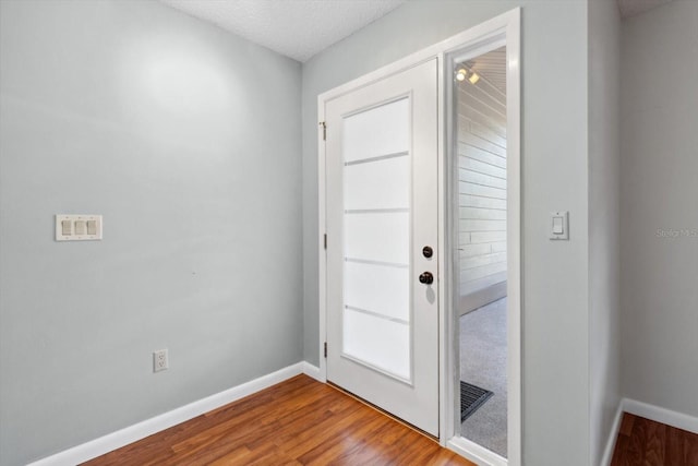 entryway featuring hardwood / wood-style floors and a textured ceiling