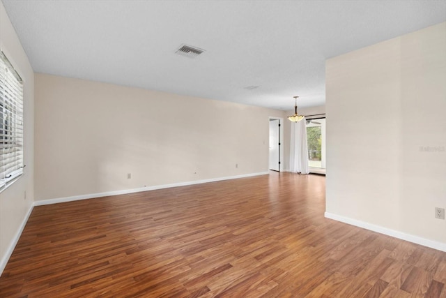 unfurnished room with wood-type flooring