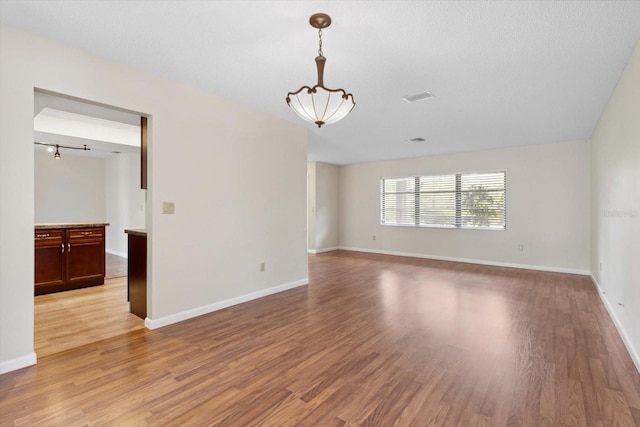 spare room with light wood-type flooring