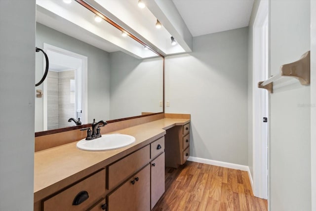 bathroom with hardwood / wood-style flooring and vanity