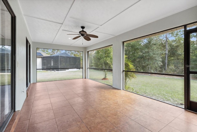 unfurnished sunroom with ceiling fan and a wealth of natural light