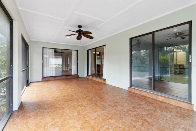 unfurnished sunroom with ceiling fan and coffered ceiling