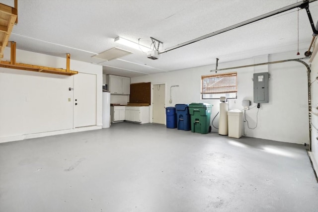 garage with electric panel and a garage door opener