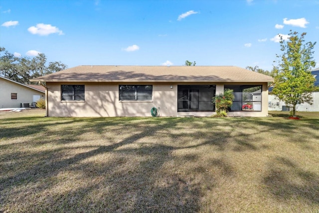 rear view of property with a lawn