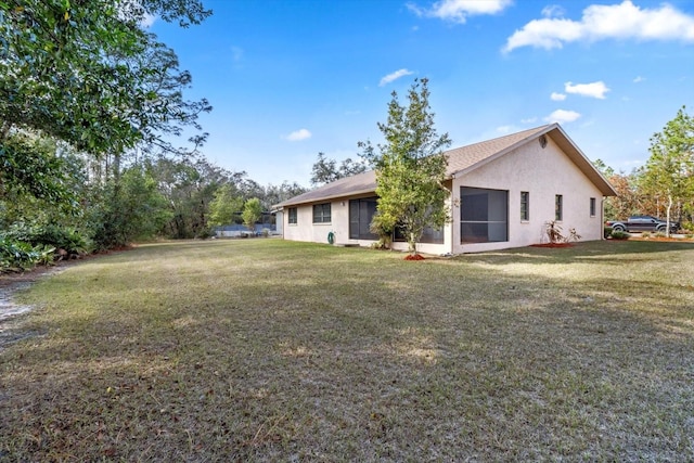 rear view of property with a yard