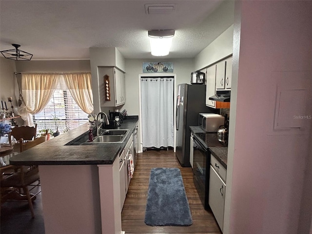 kitchen featuring a breakfast bar, white cabinetry, black electric range oven, sink, and dark hardwood / wood-style flooring