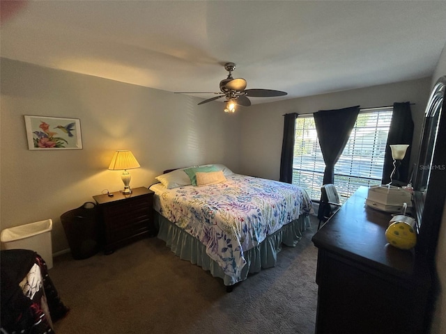 bedroom with ceiling fan and dark colored carpet