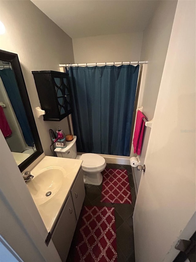 bathroom with vanity, toilet, and curtained shower