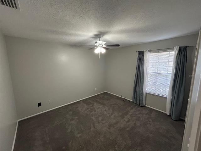 carpeted spare room with a textured ceiling and ceiling fan