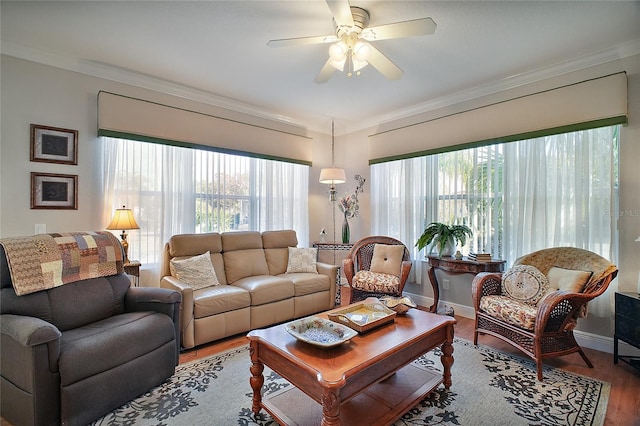 living room featuring hardwood / wood-style flooring, ornamental molding, and a healthy amount of sunlight