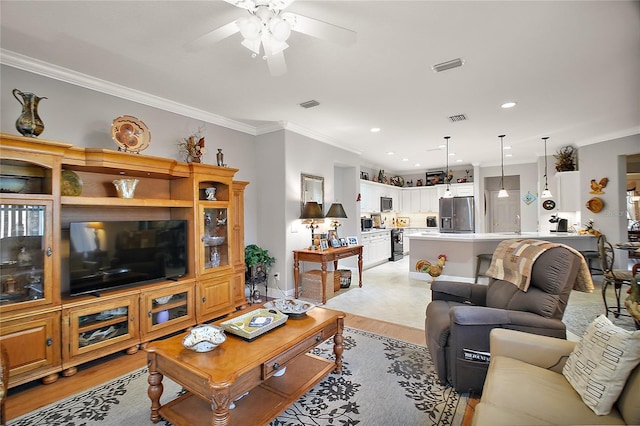 living room featuring ornamental molding, ceiling fan, and light hardwood / wood-style flooring