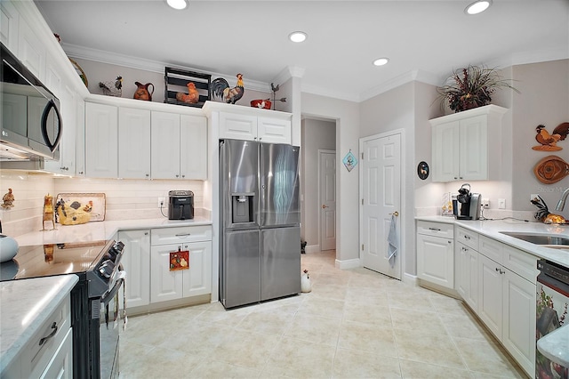 kitchen with white cabinetry, sink, decorative backsplash, stainless steel appliances, and crown molding