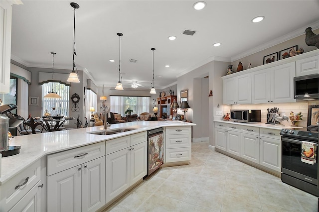 kitchen with white cabinets, sink, pendant lighting, and electric range