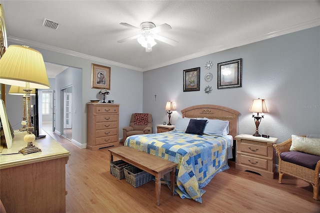 bedroom with crown molding, ceiling fan, and light wood-type flooring