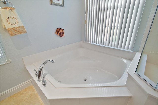 bathroom featuring tile patterned floors and a bathtub