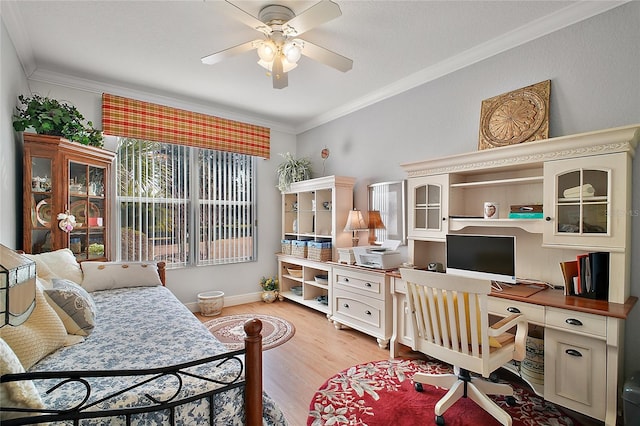 home office with ornamental molding, light hardwood / wood-style floors, and ceiling fan