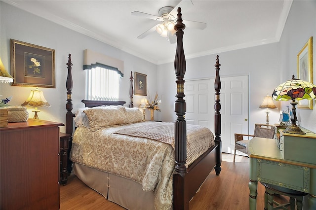 bedroom with ceiling fan, ornamental molding, and light wood-type flooring