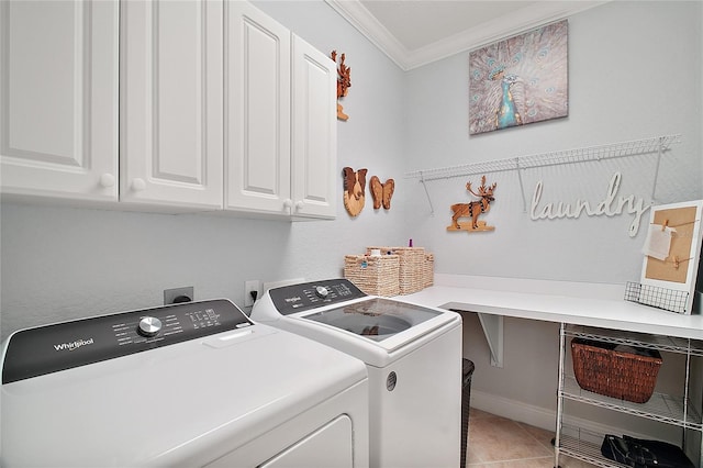 laundry area with tile patterned flooring, independent washer and dryer, crown molding, and cabinets