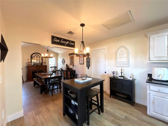 dining space featuring a chandelier and light hardwood / wood-style floors