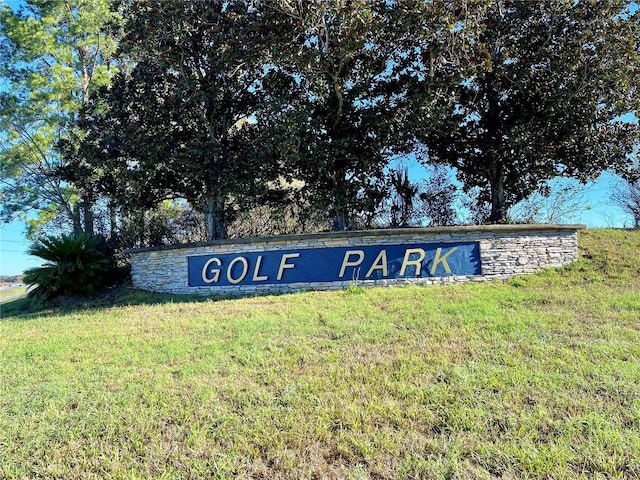 community / neighborhood sign with a yard