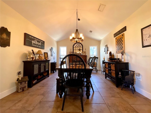 dining space with vaulted ceiling and a notable chandelier