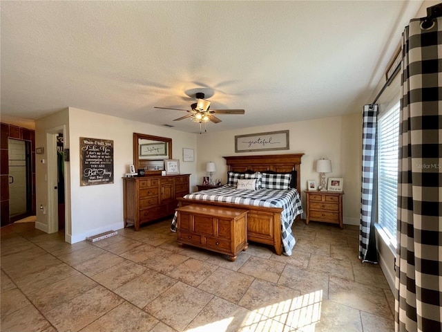 bedroom with ceiling fan and a textured ceiling