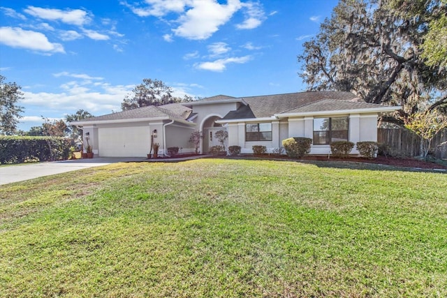 view of front of property featuring a garage and a front lawn