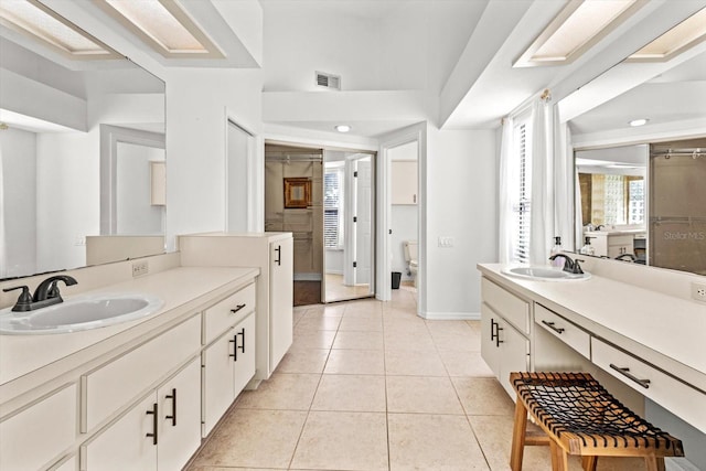 bathroom with tile patterned flooring, vanity, and toilet