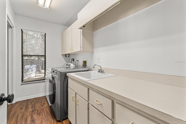 clothes washing area featuring sink, cabinets, separate washer and dryer, a textured ceiling, and dark hardwood / wood-style flooring