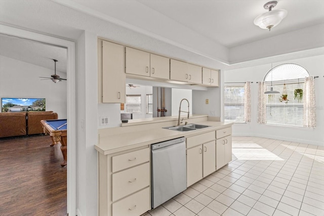 kitchen with dishwasher, sink, light tile patterned floors, ceiling fan, and cream cabinets