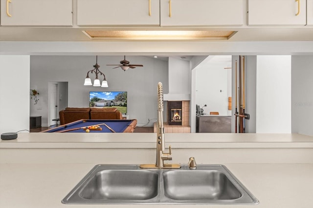 kitchen with pendant lighting, ceiling fan, and sink