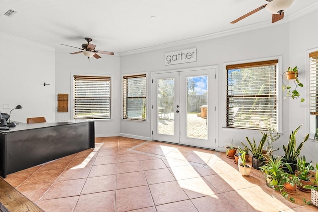 doorway to outside featuring light tile patterned floors, plenty of natural light, and ornamental molding