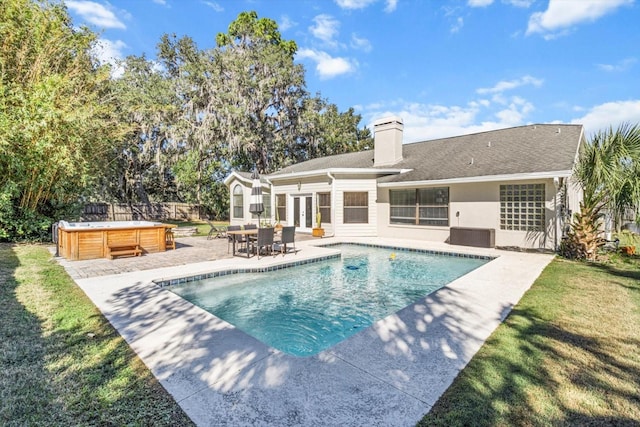 view of pool featuring french doors, a hot tub, and a patio area