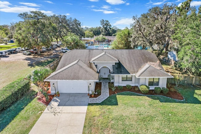 ranch-style house featuring a garage and a front yard