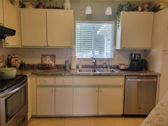 kitchen featuring sink, pendant lighting, light tile patterned floors, and stainless steel appliances