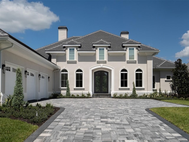 view of front of home with french doors and a garage