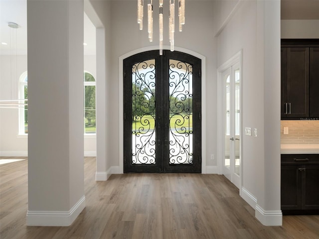 entrance foyer featuring light wood-type flooring and french doors