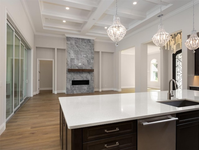 kitchen featuring a fireplace, sink, beam ceiling, coffered ceiling, and an inviting chandelier