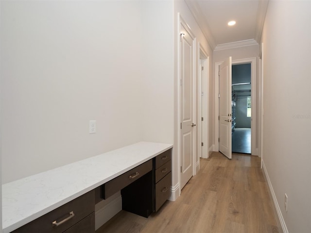 corridor featuring ornamental molding and light wood-type flooring