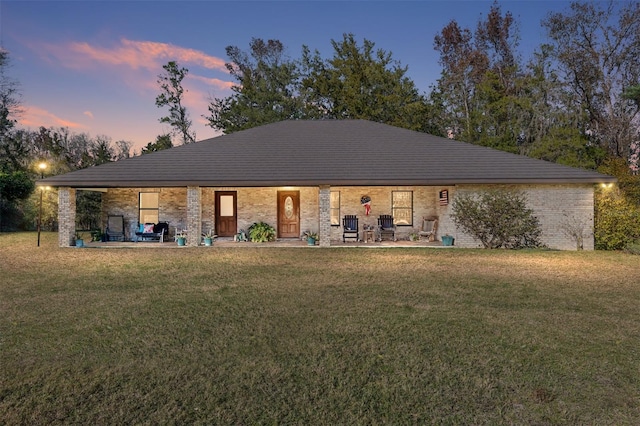 single story home with a patio area and a lawn