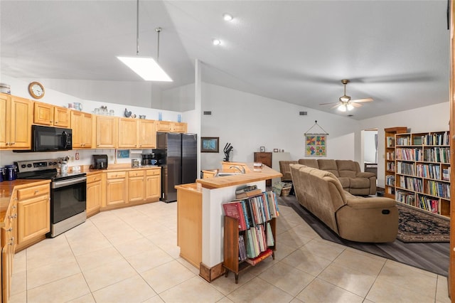 kitchen featuring light tile patterned floors, wood counters, stainless steel appliances, light brown cabinetry, and vaulted ceiling